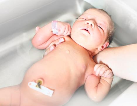 stockphotofirstbathingofanewbornbabygirlinahospitalbathtub105904067.jpg