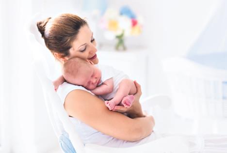 stockphotoyoungmotherholdinghernewbornchildmomnursingbabywomanandnewbornboyrelaxinawhite329743067.jpg