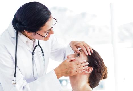 stockphotodoctorcheckingherpatientseyesinmedicaloffice273590450.jpg