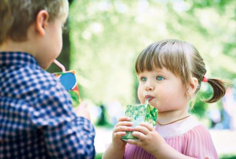 stockphotolovelylittlegirlandboydrinkingjuice627895310.jpg