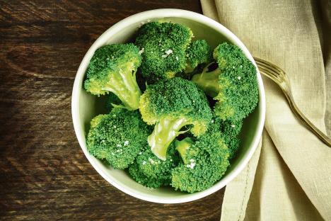 stockphotoabowlofcookedgreenbroccoliwithseasaltshotfromaboveonadarkwoodenrustictexturewith638971492.jpg