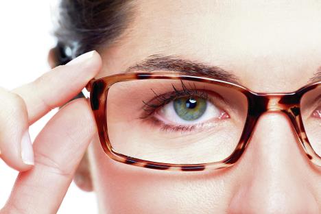 stockphotoeyeglasseswomanwearingeyeglassesoptometristbackground160345610.jpg