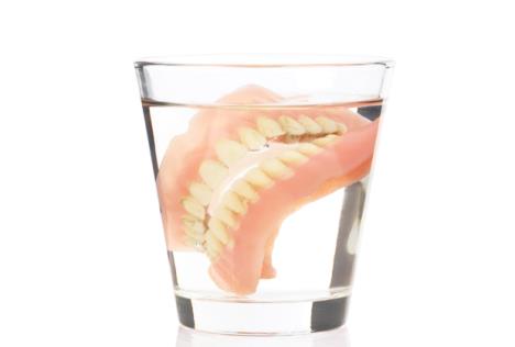 stockphotoolddenturesinaglassofwater51603103.jpg