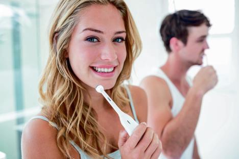 stockphotoyoungcouplebrushingtheirteethathomeinthebathroom557049502.jpg