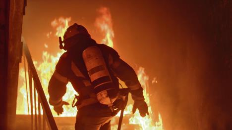 stockphotobravefirefighterrunsupthestairsragingfireisseeneverywhere678729862.jpg