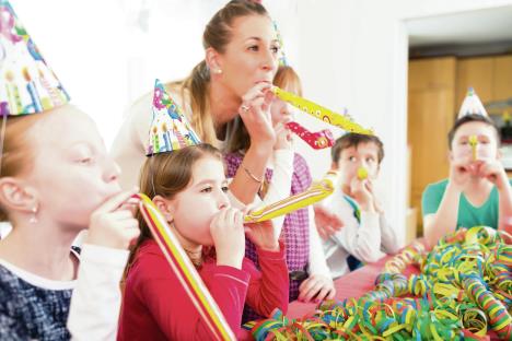 stockphotochildrenhavingbirthdaypartywithfunblowingstreamersgroupofkidswithmother272946800.jpg