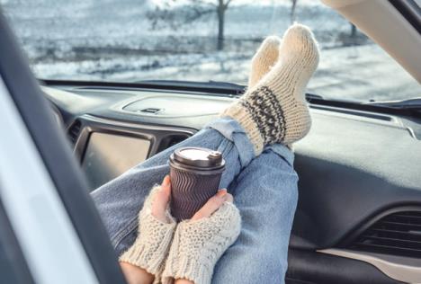 stockphotoyoungwomaninwarmsocksholdingherlegsoncardashboardanddrinkingcoffeecozyatmosphere1301334790.jpg