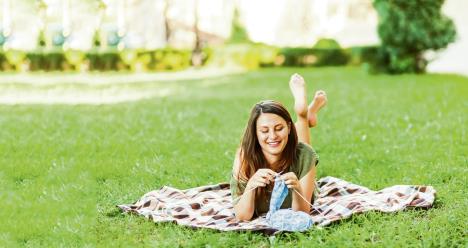 stockphotoayoungwomansittinginacityparkongreengrassandknittingabluesweaterwithknitting1351541705.jpg