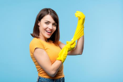 fraj-stockphotoyounghousekeeperputtingonyellowrubberglovesbeforehousework1470309047.jpg