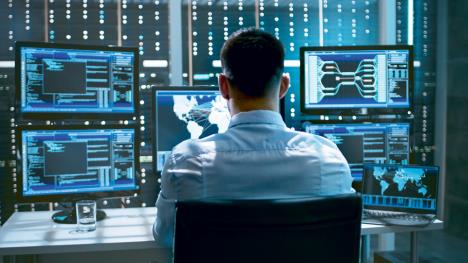 stockphotosystemsecurityspecialistworkingatsystemcontrolcenterroomisfullofscreensdisplaying669226093.jpg