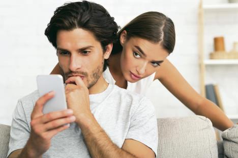 stockphotodistrustjealouswifespyingoncheatinghusbandwhilehetextingonphonestandingbehindhis1516839095.jpg