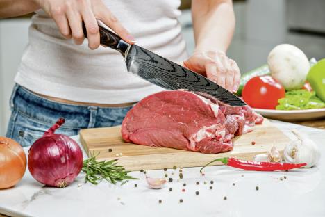 stockphotocloseupofwomanshandscookinginthekitchenhousewifeslicingfreshmeat1544515655.jpg