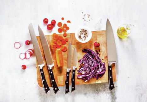 stockphotosetofnewprofessionalkitchenknivesonawoodencuttingboardandvegetables1006765006.jpg