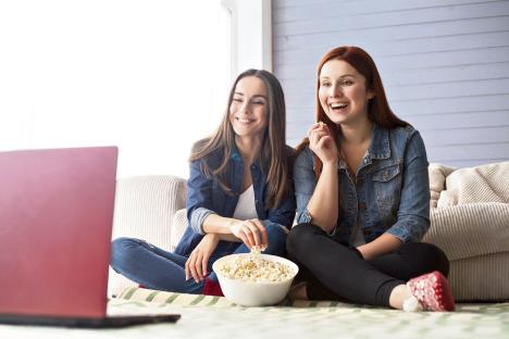 stockphototwogirlfriendssittingonthefloornearthecouchinfrontofthemthereisacomputeronwhich583880023-23-12-2019.jpg