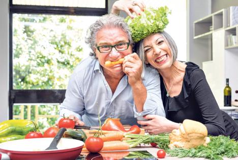 stockphotoseniorcouplehavingfuninkitchenwithhealthyfoodretiredpeoplecookingmealathomewith424476892.jpg