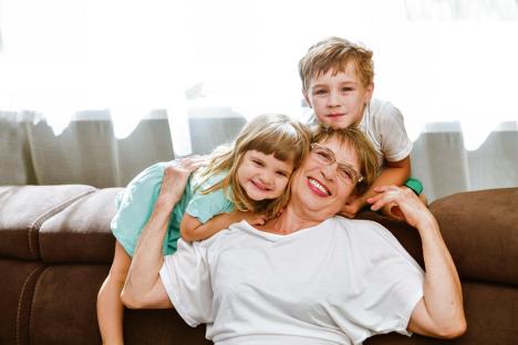 stockphotohappymiddleagedmaturegrandmaandlittlepreschoolertwograndsonshavingfunplayingathome1453559777.jpg