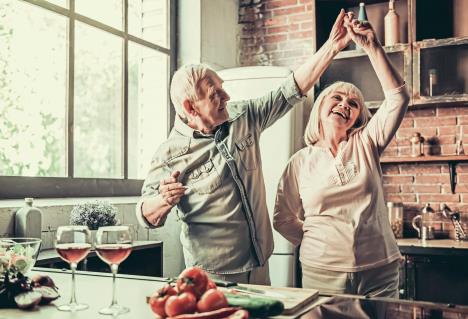 stockphotobeautifulseniorcoupleisdancingandsmilingwhilecookingtogetherinkitchen653481589.jpg