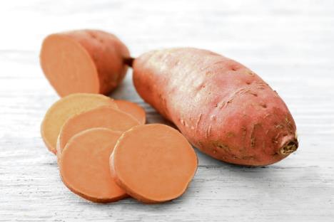 stockphotorawsweetpotatoonwoodentable750493000.jpg