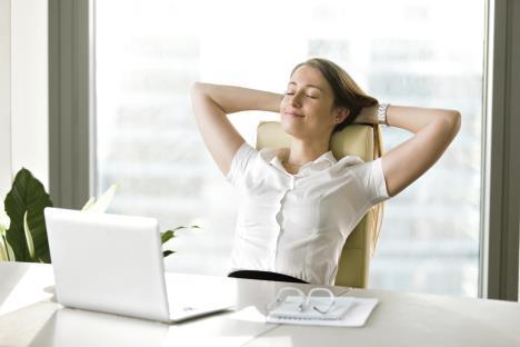 stockphotocalmsmilingbusinesswomanrelaxingatcomfortableofficechairhandsbehindheadhappywoman729605338.jpg