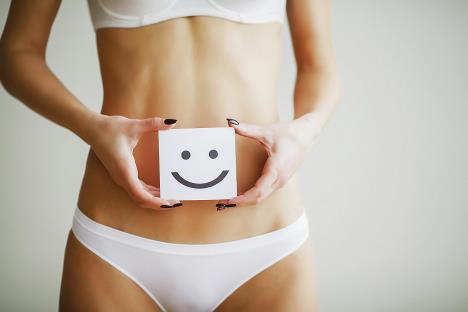 stockphotowomenhealthcloseupofhealthyfemalewithbeautifulfitslimbodyinwhitepantiesholdingwhite1023401959.jpg