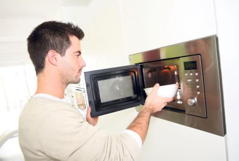 stockphotomanheatingfoodinmicrowave168084011.jpg