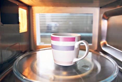 stockphotowarmingcupofcoffeeinsidemicrowaveoven234672856.jpg