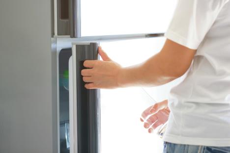 stockphotoabstracthandayoungwomanisopeningarefrigeratordoor641157607.jpg