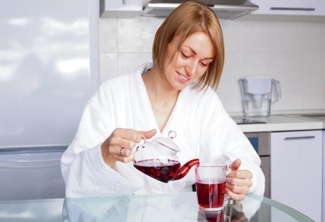 stockphotobeautifulhappyyoungwomandrinkingteaathomeinthemorning64565596.jpg