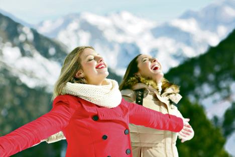 stockphototwohappyfriendsbreathingfreshairinwinterinasnowymountain769618150.jpg