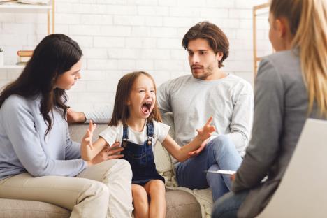 stockphotoproblemchildshockedparentssoothingtheirscreaminglittledaughteratpsychologist1619924656.jpg