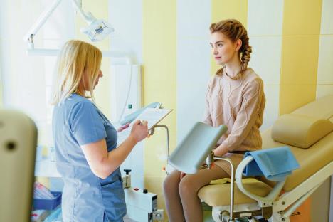 stockphotoyoungblondwomanhavinggynecologyconsultationinmedicalclinic1067786012.jpg