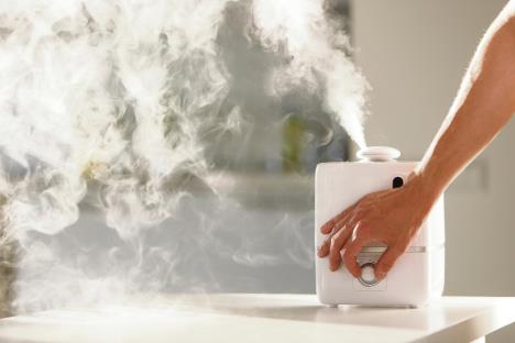 stockphotohandturnonaromaoildiffuseronthetableathomesteamfromtheairhumidifierultrasonic1425864038.jpg