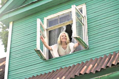 stockphotoseniorblondewomanopeningwindowinthemorningmorningwakingupactivemorningatthecountry1430249603.jpg