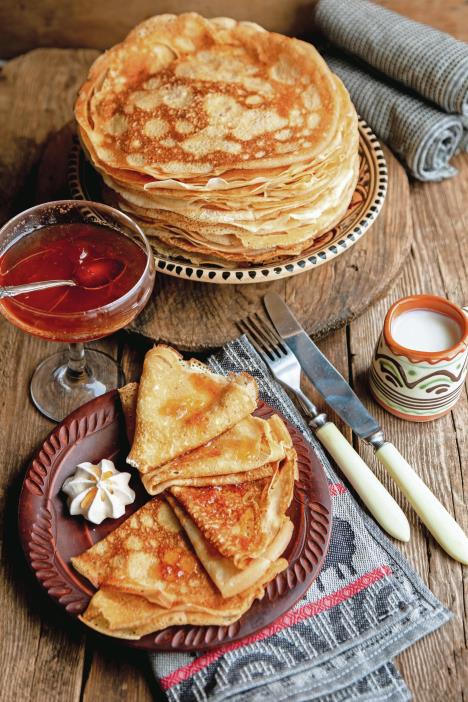 stockphotothinpancakesforshrovetidepancakefromthindoughintowhichvariousfillingisstuffed1657396114.jpg
