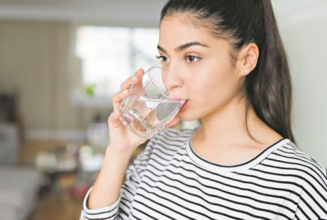 stockphotobeautifulyoungwomandrinkingafreshglassofwaterathome1379304191.jpg