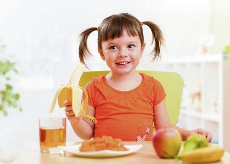 stockphotobeautifulchildgirleatinghealthyfoodfruitsathome334917527.jpg