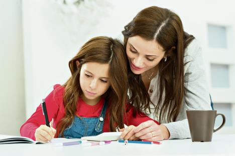 stockphotohappyyoungmotherhelpingherdaughterwhilestudyingathome185899193.jpg