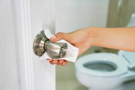 stockphotocloseupofasianwomanhandusingwhitetoiletpapertouchthepublictoiletdoorknobtoprevent1680859006.jpg