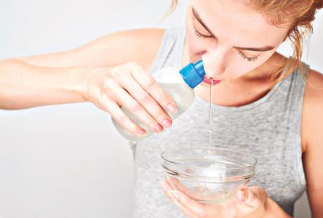 stockphototreatmentandpreventionofthecommoncoldthegirlwashesoutthenosewithsaline753161953.jpg