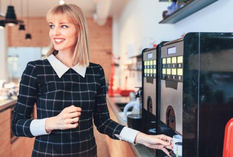 stockphotoyoungattractivewomanmakingacoffeeinanofficecafeteria1039104424.jpg