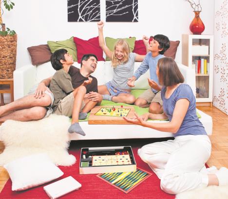 stockphotoayoungfamilyisplayingboardgamesintheirbed58926421.jpg