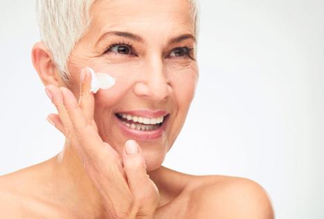 stockphotoheadshotofbeautifulseniorwomanputtingonthecream1070532419.jpg