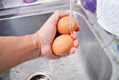 stockphotowashingeggswithwaterinkitchen794998144.jpg