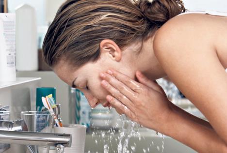 stockphotocloseupofbeautifulyoungwomanwashingfaceinbathroom146566598.jpg