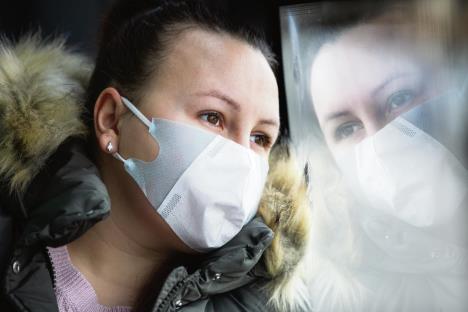 stockphotocoronaviruscovidyoungwomanwithrespiratorymasktravelinginthepublictransportbybus1657907020.jpg