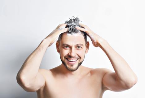 stockphotoyounghandsomemanwashinghaironwhitebackground587748887.jpg