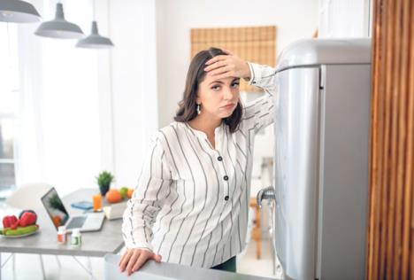 stockphotowantingtoeatdarkhairedwomaninastripedblousefeelingfrustrated1637980864.jpg