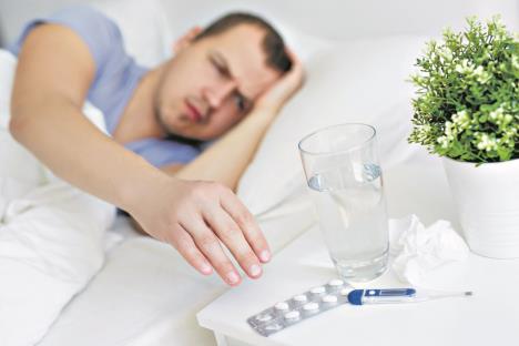 0809-stockphotohealthcareandillnessconceptsickmanwithfevertakingpillsorglassofwaterfrombedside1789759568.jpg