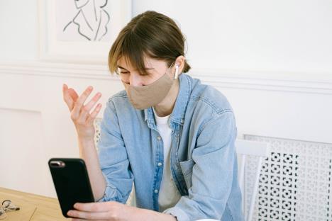 womaninfacemaskhavingvideocall4240577.jpg