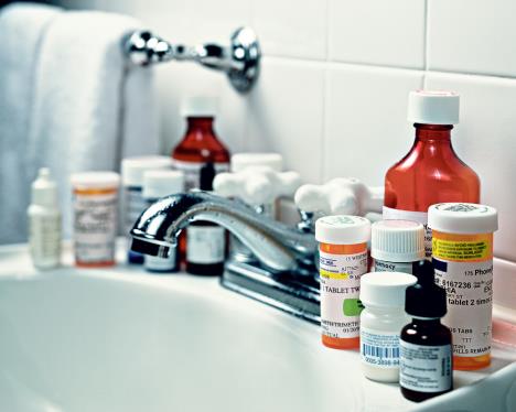 stockphotoselectivefocusimagewithmanyprescriptionmedicinebottlesonbathroomsink1428628607.jpg